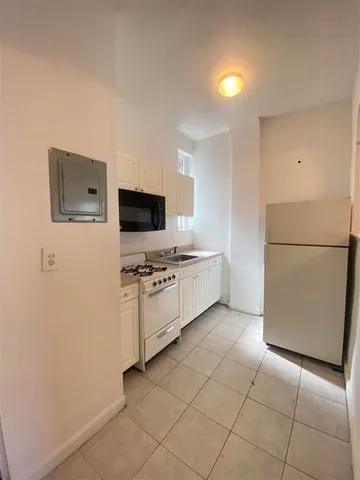 a kitchen with stainless steel appliances a refrigerator stove and microwave