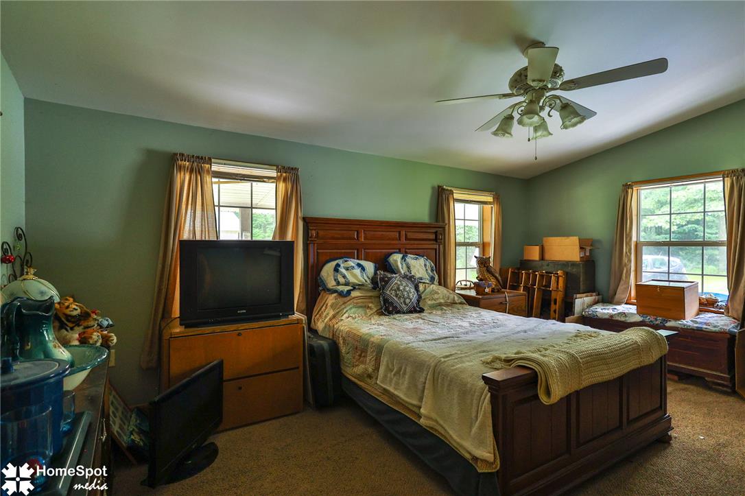 3795 Rhoades Road Kempton, PA 19529 - Photo 23 of 42 Relax in this tranquil bedroom, featuring a warm wooden bed frame and inviting natural light.