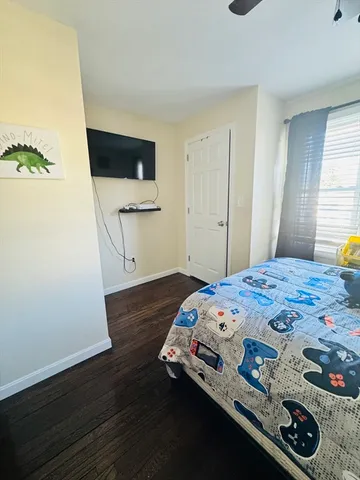 a bedroom with a bed and a mirror