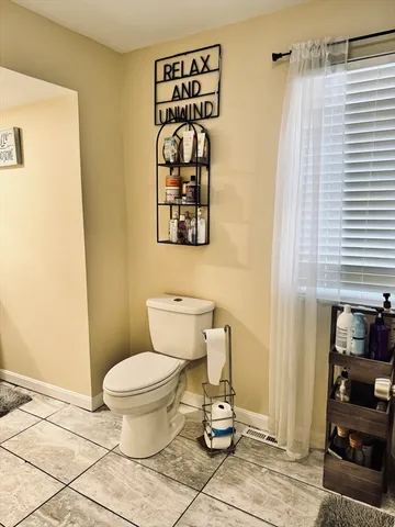 a view of a door with wooden floor and a curtain