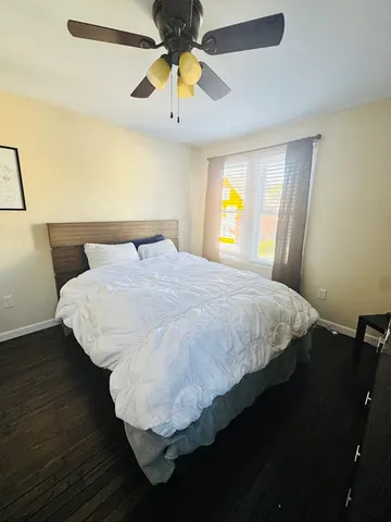 a living room with a couch and a ceiling fan
