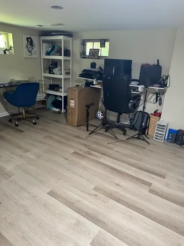 a view of a balcony with wooden floor and outdoor seating