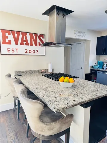 a kitchen with a table and chairs