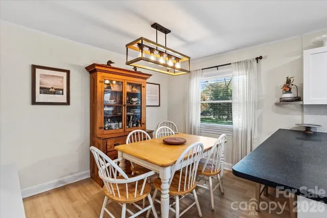 a bedroom with a bed a chair and a large window