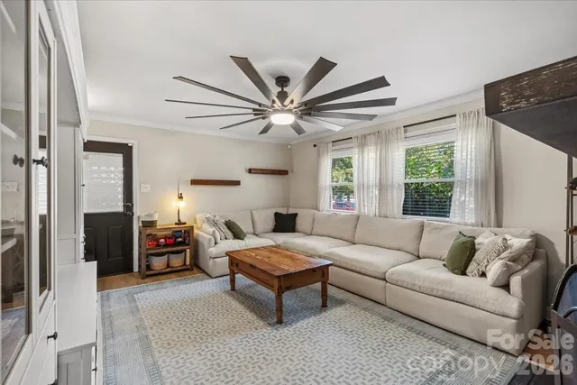 a kitchen with stainless steel appliances kitchen island granite countertop a kitchen island a stove a dining table and chairs with wooden floor