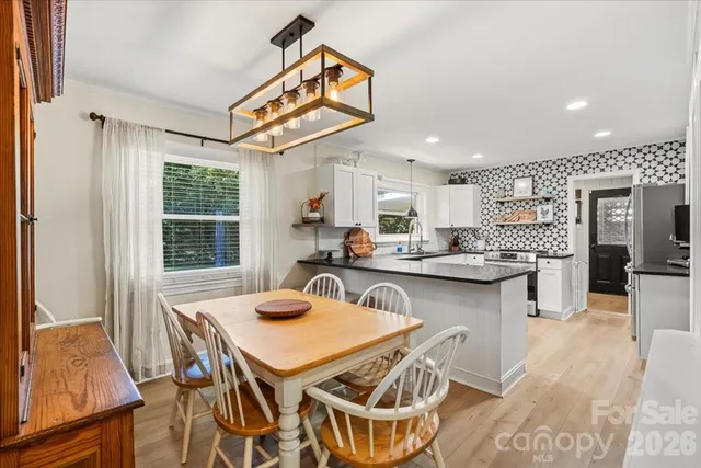 a kitchen with stainless steel appliances kitchen island granite countertop a sink and cabinets