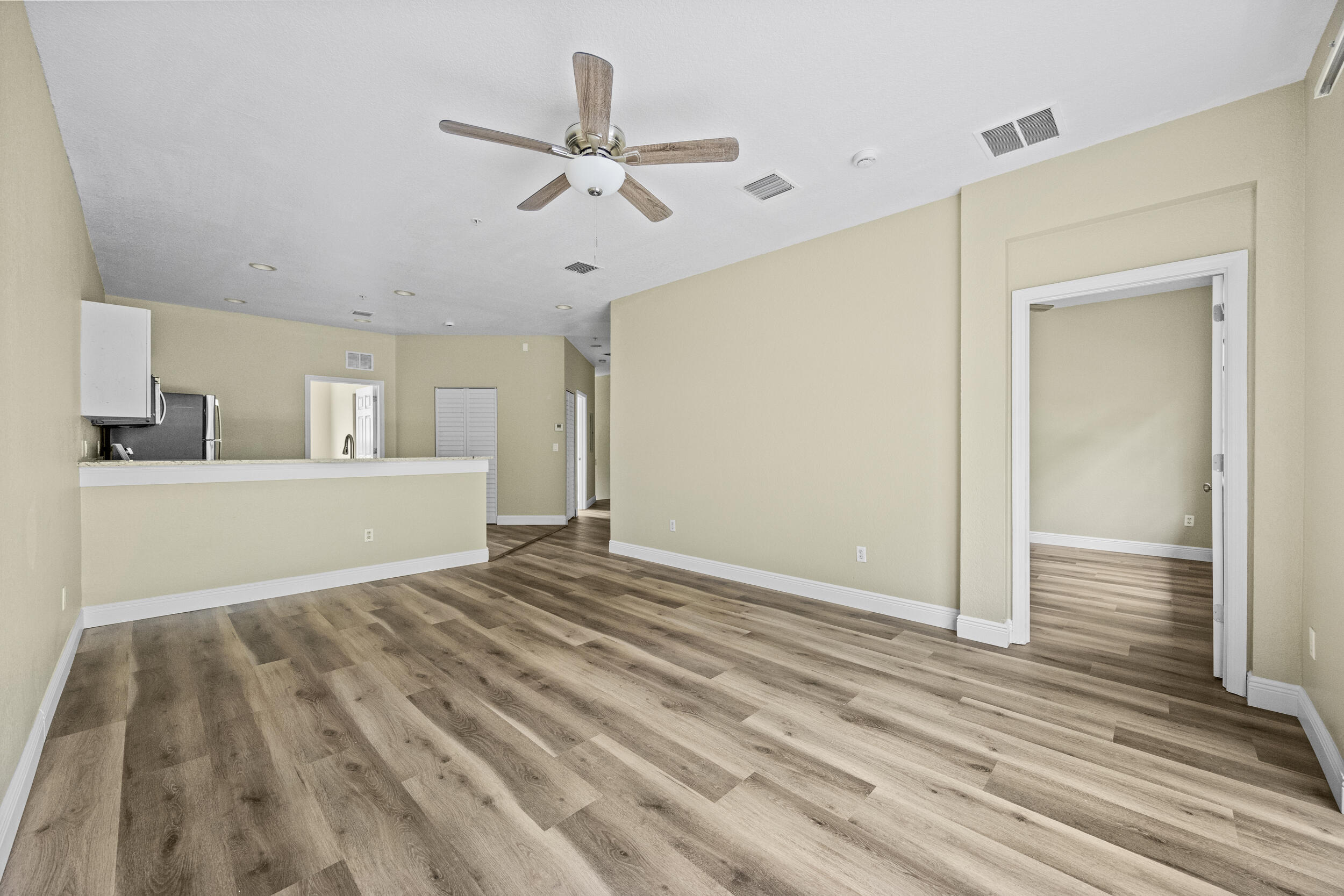 1982 Freeport Drive Riviera Beach, FL 33404 - Photo 12 of 29 a view of a livingroom with a hardwood floor and a ceiling fan