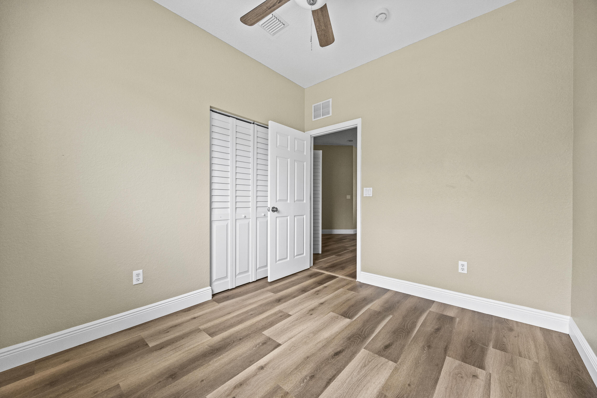 1982 Freeport Drive Riviera Beach, FL 33404 - Photo 24 of 29 an empty room with a empty space and chandelier fan