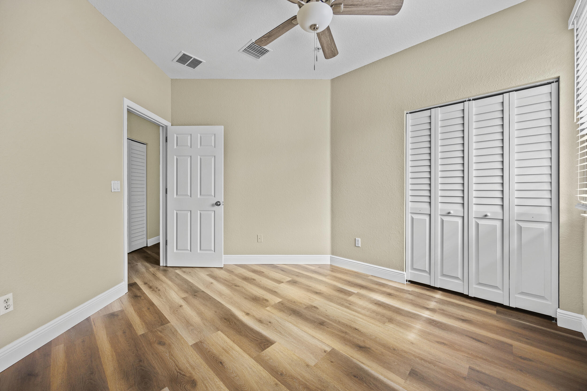 1982 Freeport Drive Riviera Beach, FL 33404 - Photo 28 of 29 a view of an empty room with wooden floor