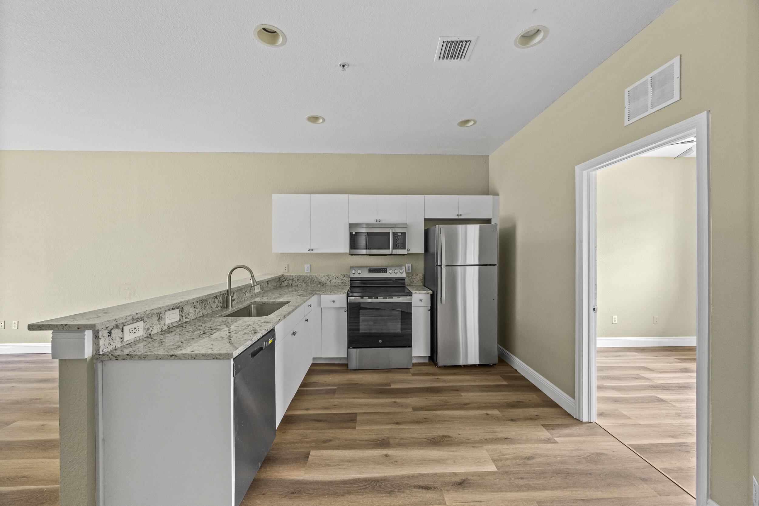 1982 Freeport Drive Riviera Beach, FL 33404 - Photo 8 of 29 a kitchen with stainless steel appliances granite countertop a refrigerator and a sink