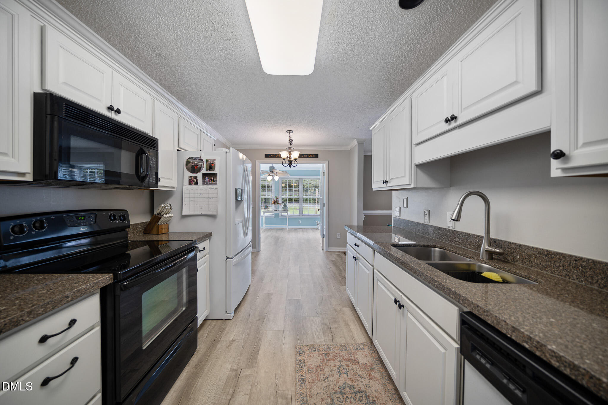168 Tanning Ridge Drive Dunn, NC 28334 - Photo 15 of 33 a kitchen with stainless steel appliances a stove sink microwave and cabinets