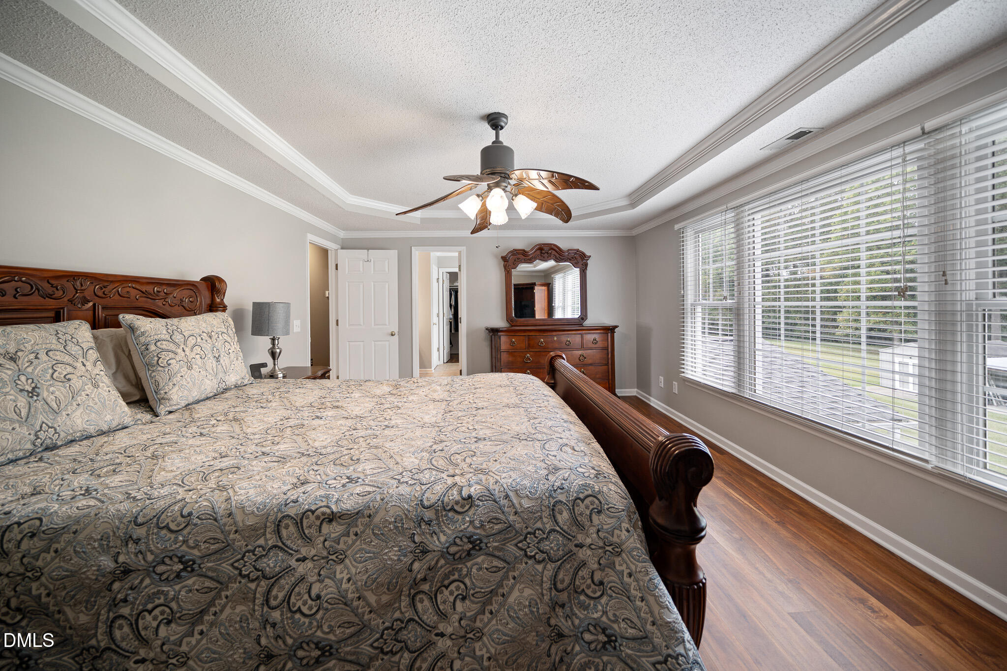 168 Tanning Ridge Drive Dunn, NC 28334 - Photo 20 of 33 a bedroom with a large bed and a chandelier
