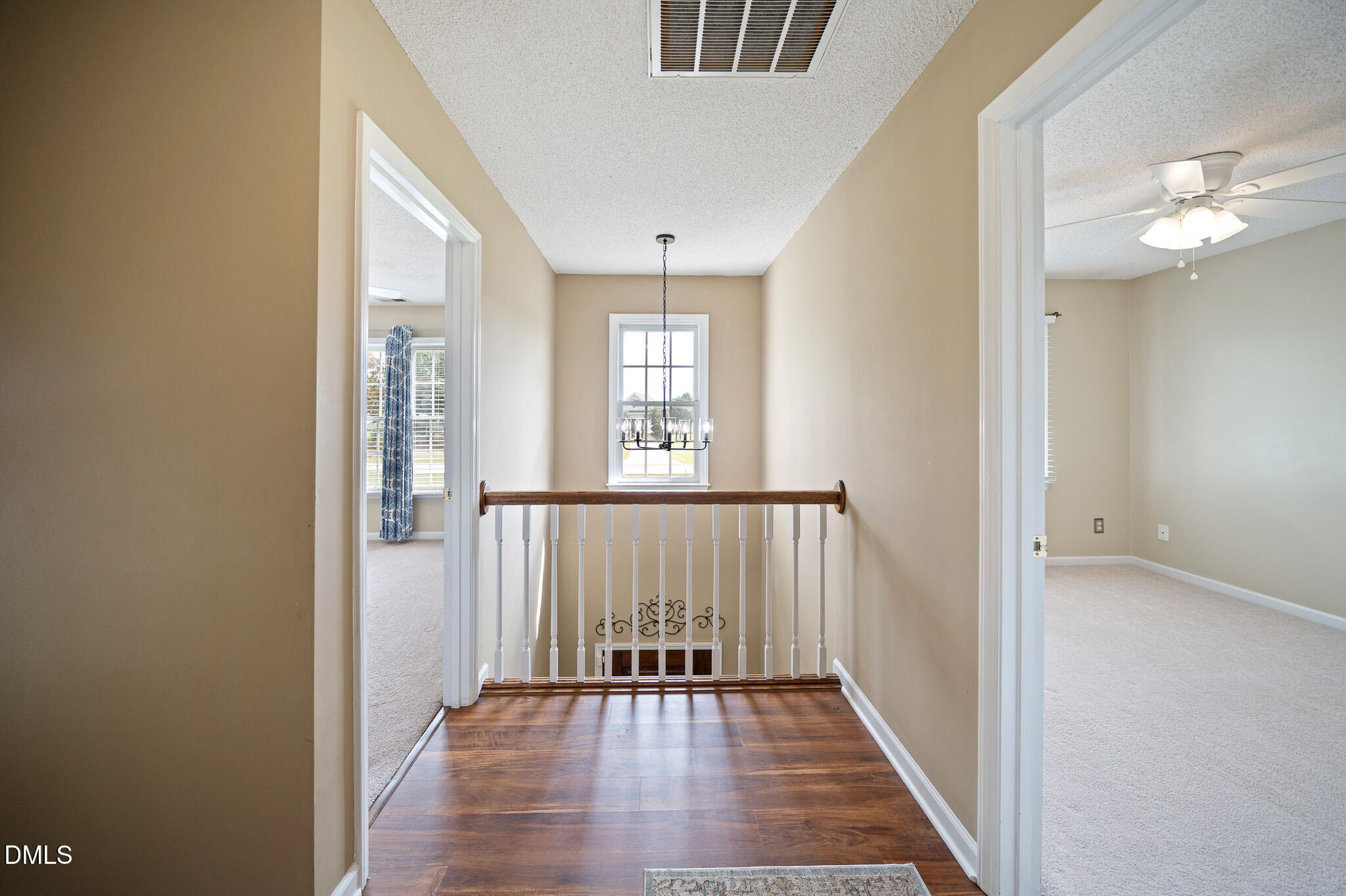 168 Tanning Ridge Drive Dunn, NC 28334 - Photo 27 of 33 a view of a hallway with wooden floor and a chandelier