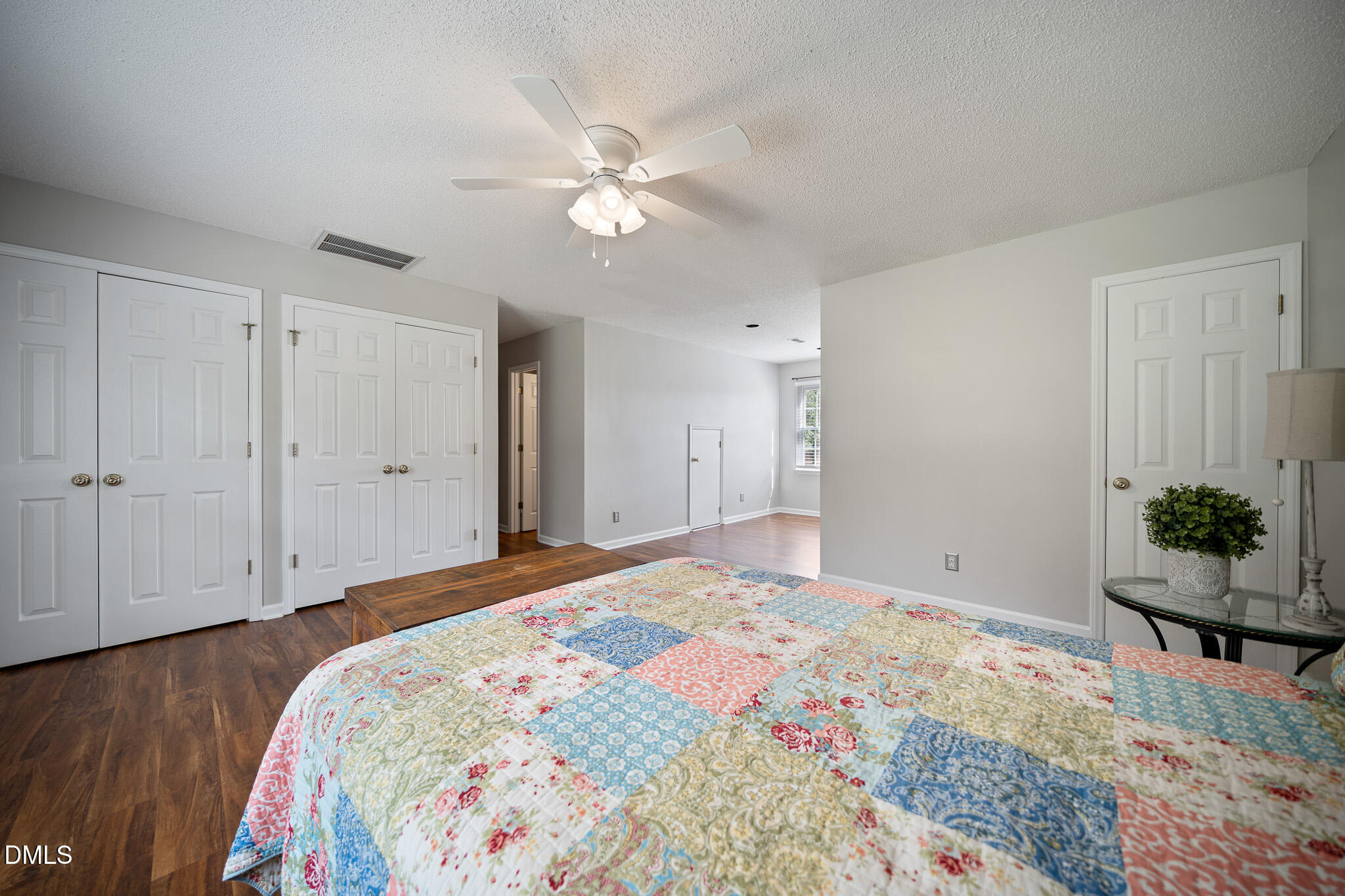 168 Tanning Ridge Drive Dunn, NC 28334 - Photo 30 of 33 a bedroom with a large bed and a chandelier