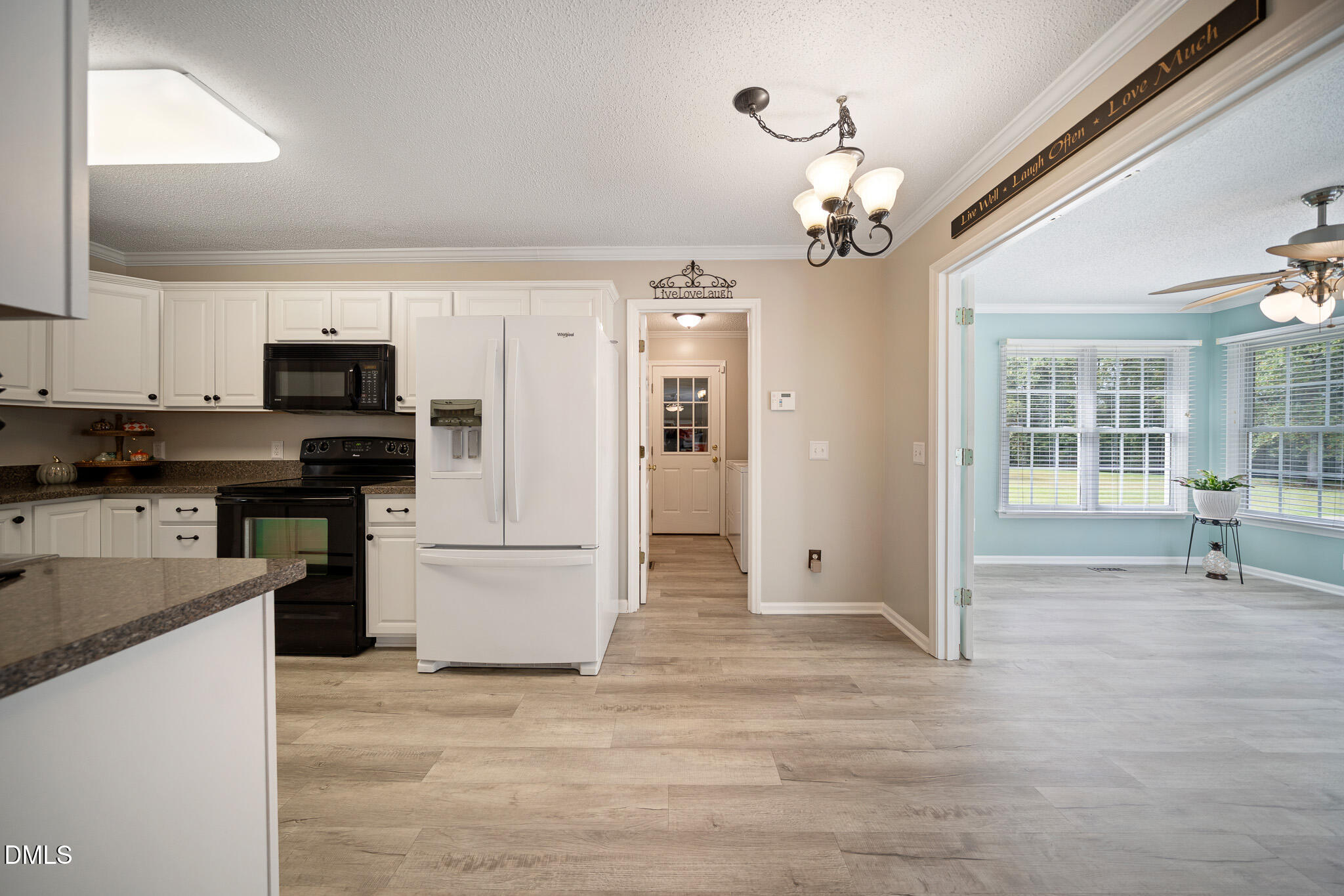168 Tanning Ridge Drive Dunn, NC 28334 - Photo 8 of 33 a kitchen with kitchen island granite countertop appliances cabinets and a sink