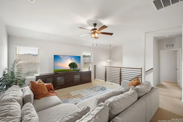 a bedroom with a bed and dresser with wooden floor