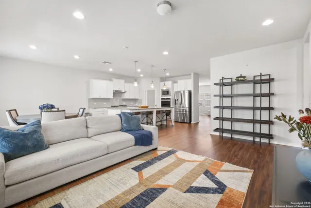 a living room with furniture and view of kitchen