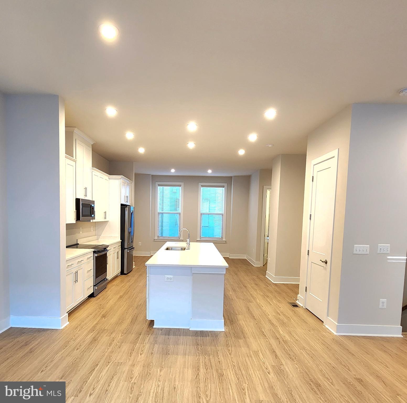 2391 Liberty Loop Herndon, VA 20171 - Photo 13 of 30 a large room with a large window and wooden floor