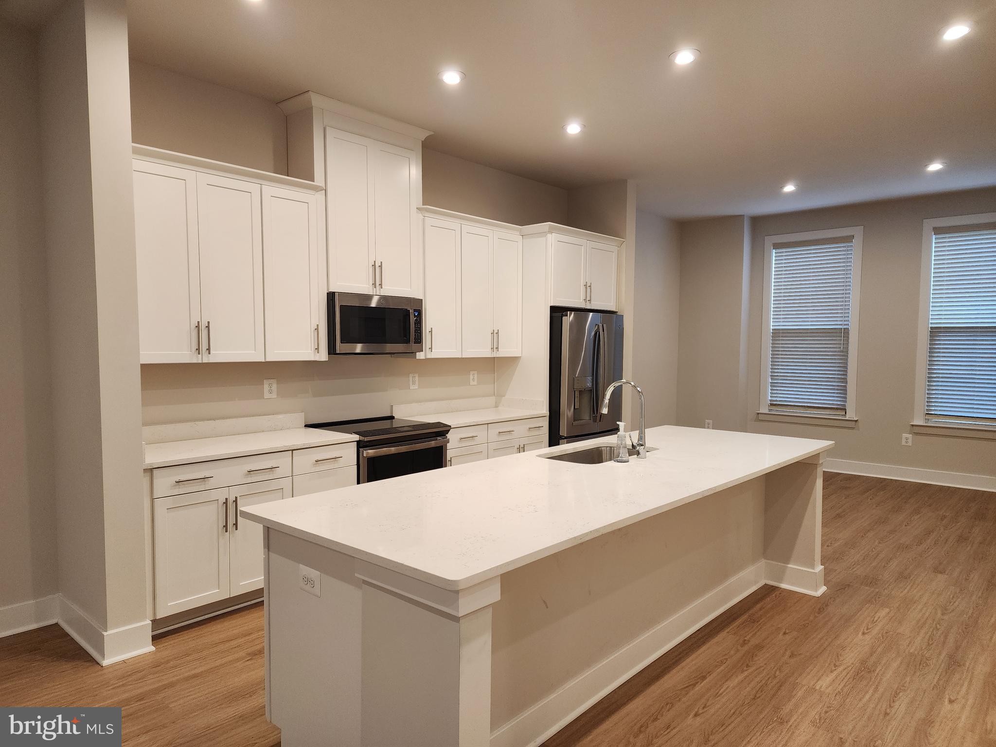 2391 Liberty Loop Herndon, VA 20171 - Photo 14 of 30 a kitchen that has a sink and a stove in it