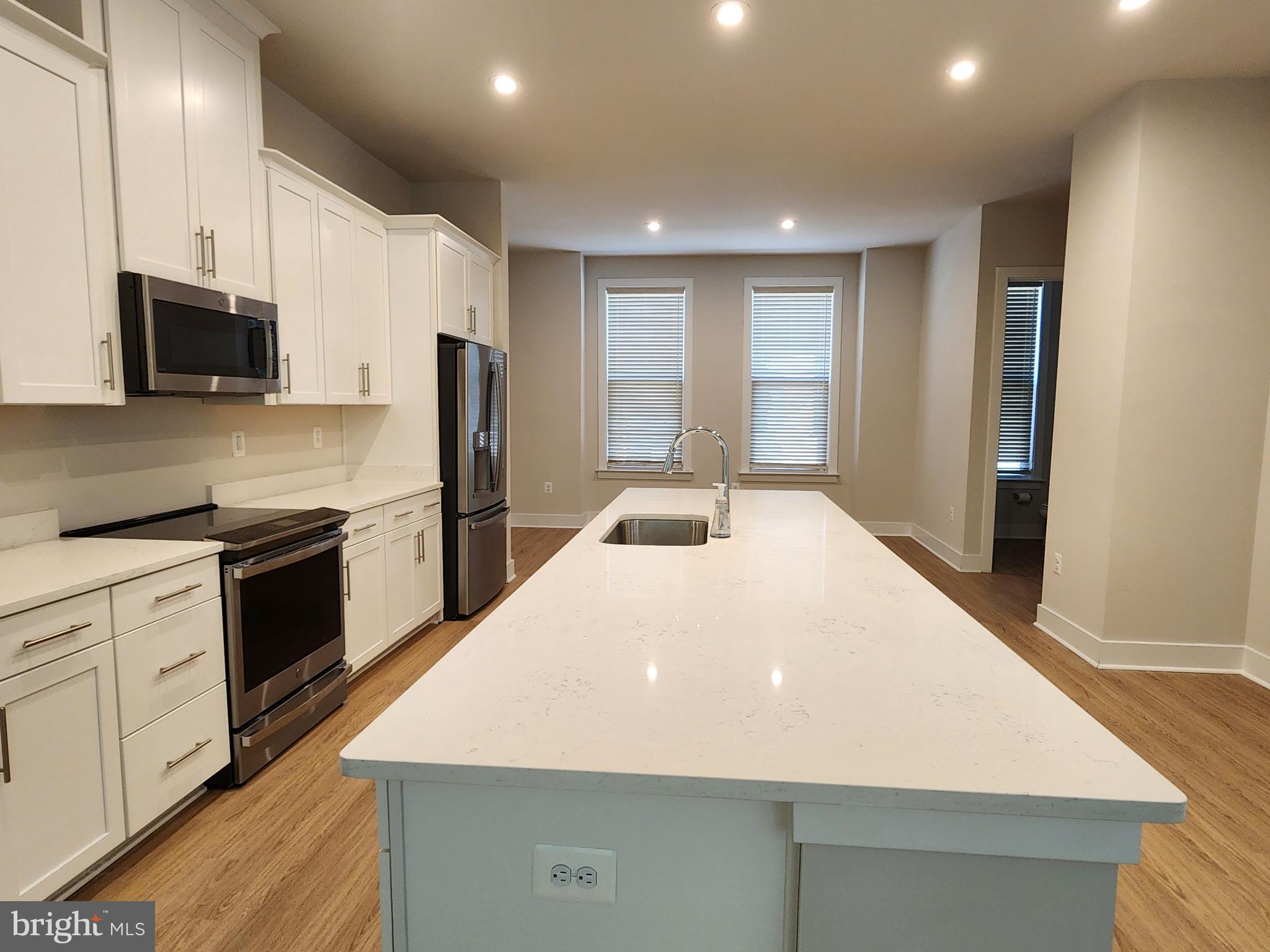 2391 Liberty Loop Herndon, VA 20171 - Photo 15 of 29 a large kitchen with kitchen island a sink dishwasher stove and refrigerator