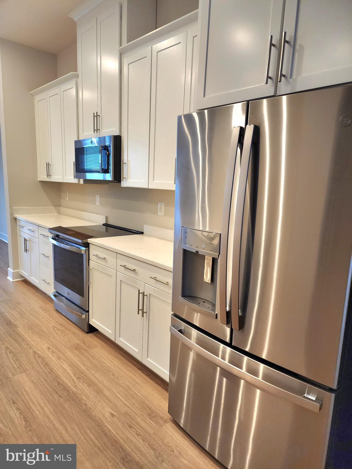 2391 Liberty Loop Herndon, VA 20171 - Photo 17 of 29 a kitchen with stainless steel appliances a refrigerator a sink and white cabinets