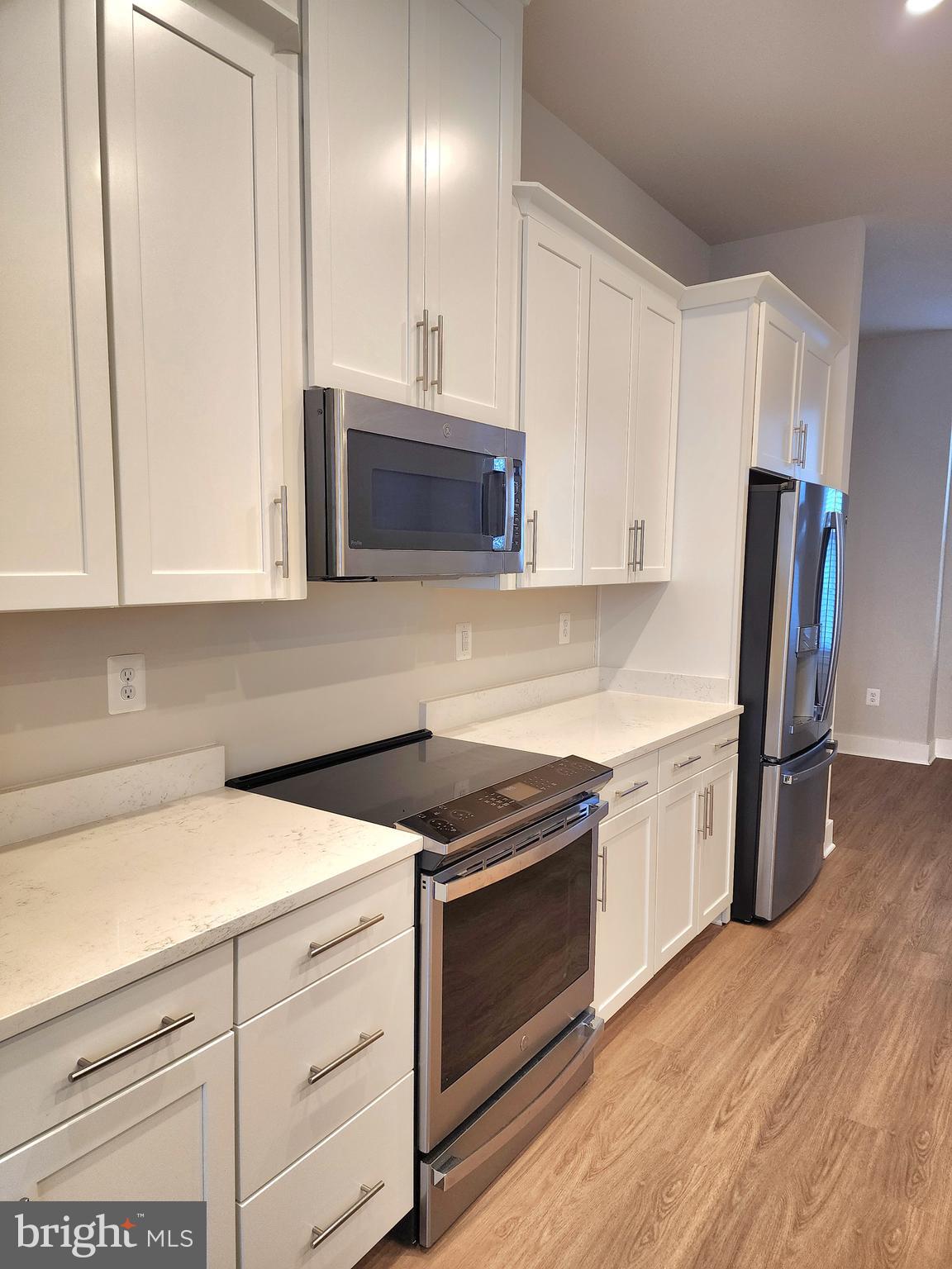 2391 Liberty Loop Herndon, VA 20171 - Photo 18 of 29 a kitchen with stainless steel appliances a stove a sink and a refrigerator