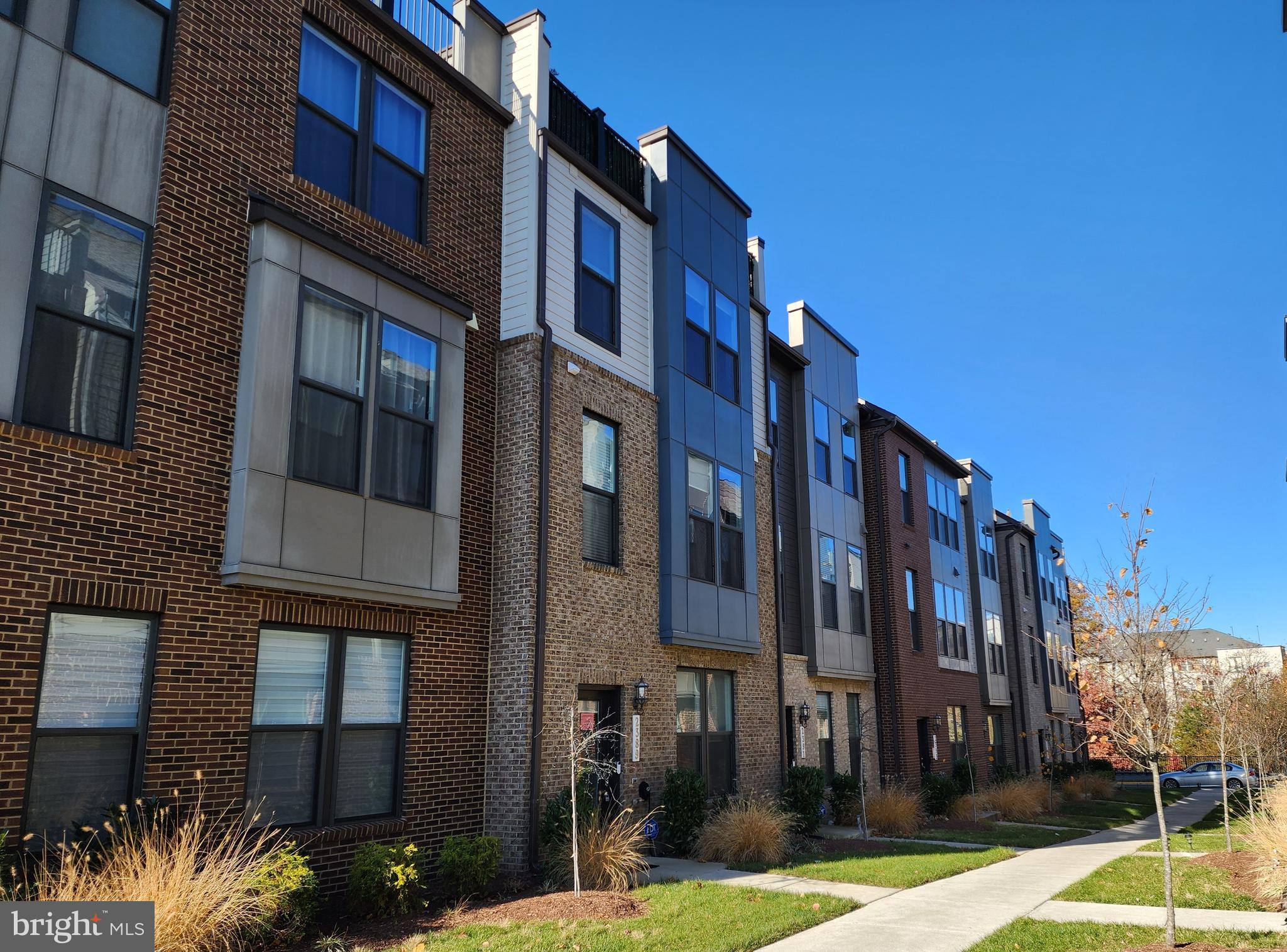 2391 Liberty Loop Herndon, VA 20171 - Photo 2 of 29 a city street lined with tall buildings