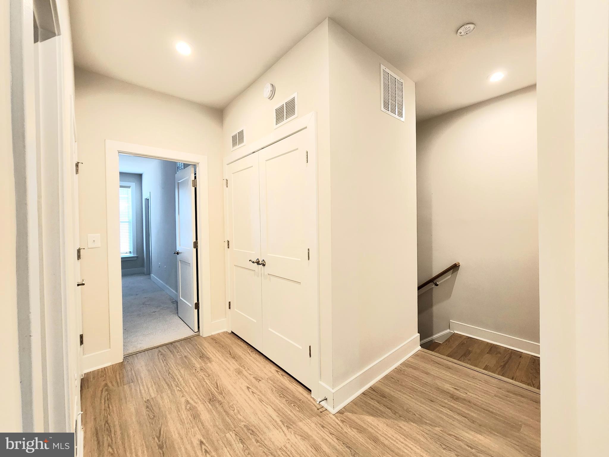 2391 Liberty Loop Herndon, VA 20171 - Photo 22 of 29 a view of a hallway with wooden floor