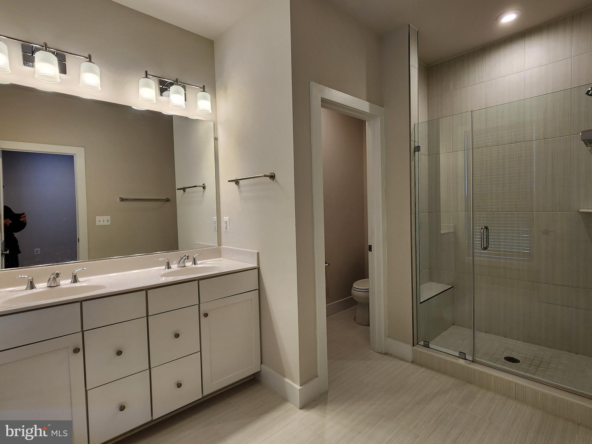 2391 Liberty Loop Herndon, VA 20171 - Photo 4 of 30 a bathroom with a double vanity sink mirror and shower