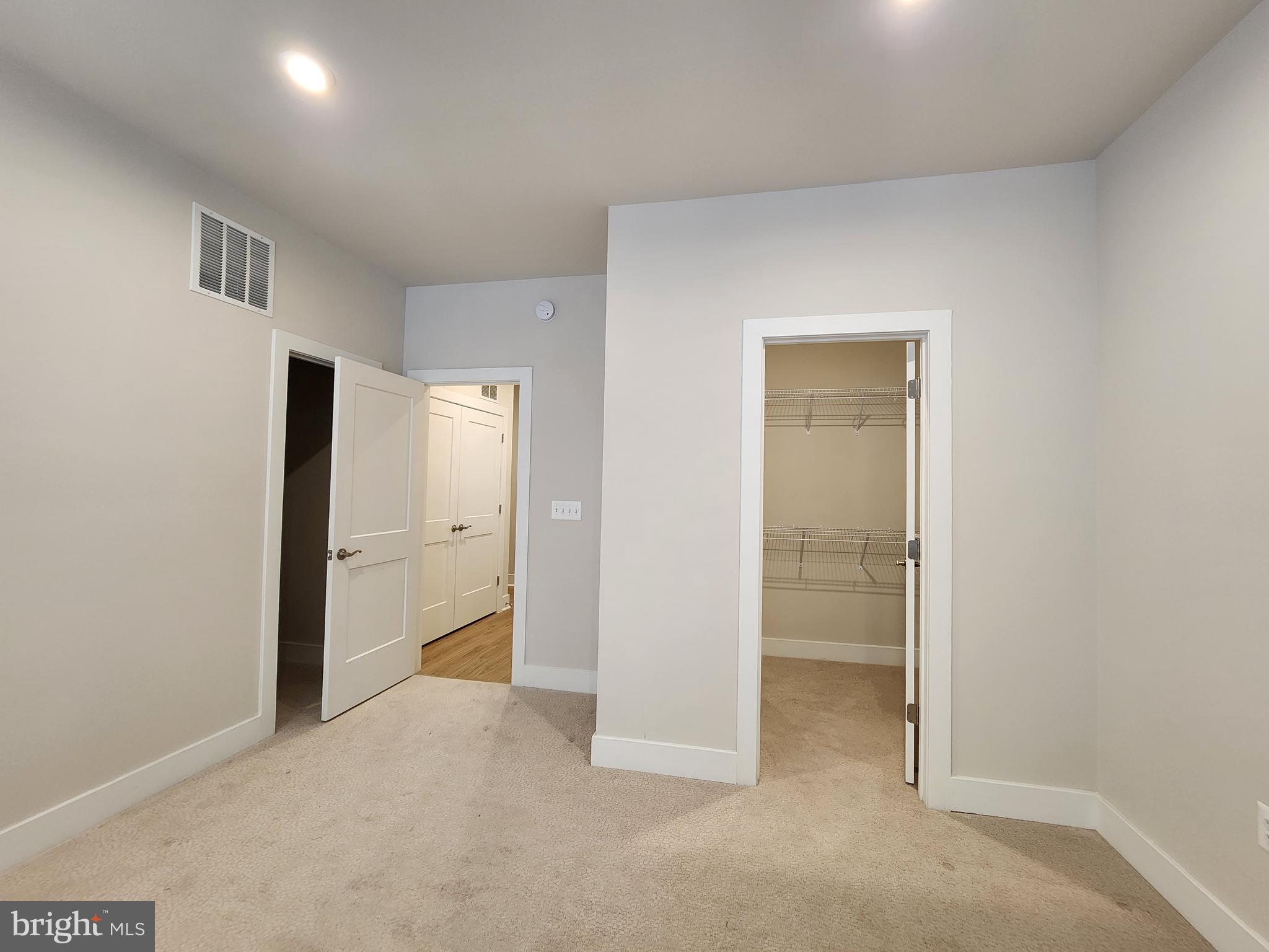 2391 Liberty Loop Herndon, VA 20171 - Photo 4 of 29 an empty room with closet and wooden floor