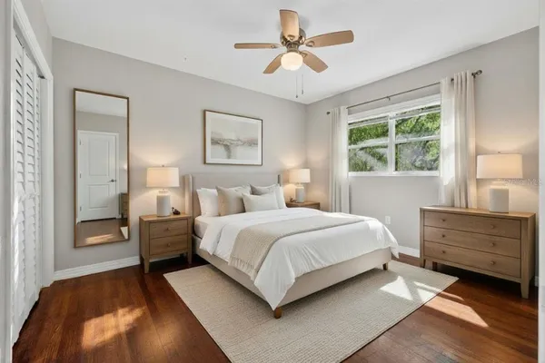 a spacious bedroom with a bed and a chandelier