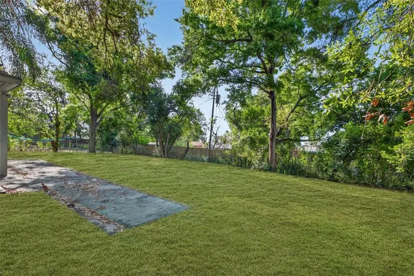 a backyard of a house with lots of green space and fountain