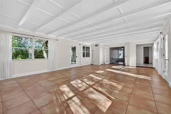 a view of a livingroom with wooden floor and a rug