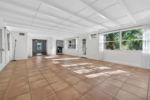 a view of a livingroom with wooden floor and a rug