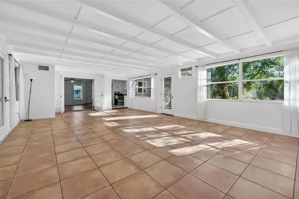 a view of a livingroom with wooden floor and a rug
