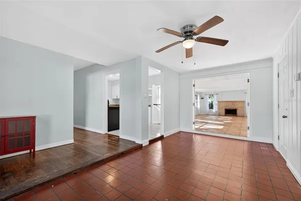 a view of a livingroom with a ceiling fan and wooden floor