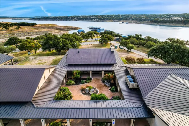 a view of a balcony with wooden floor and lake view