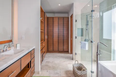 a bathroom with a granite countertop sink a mirror and shower