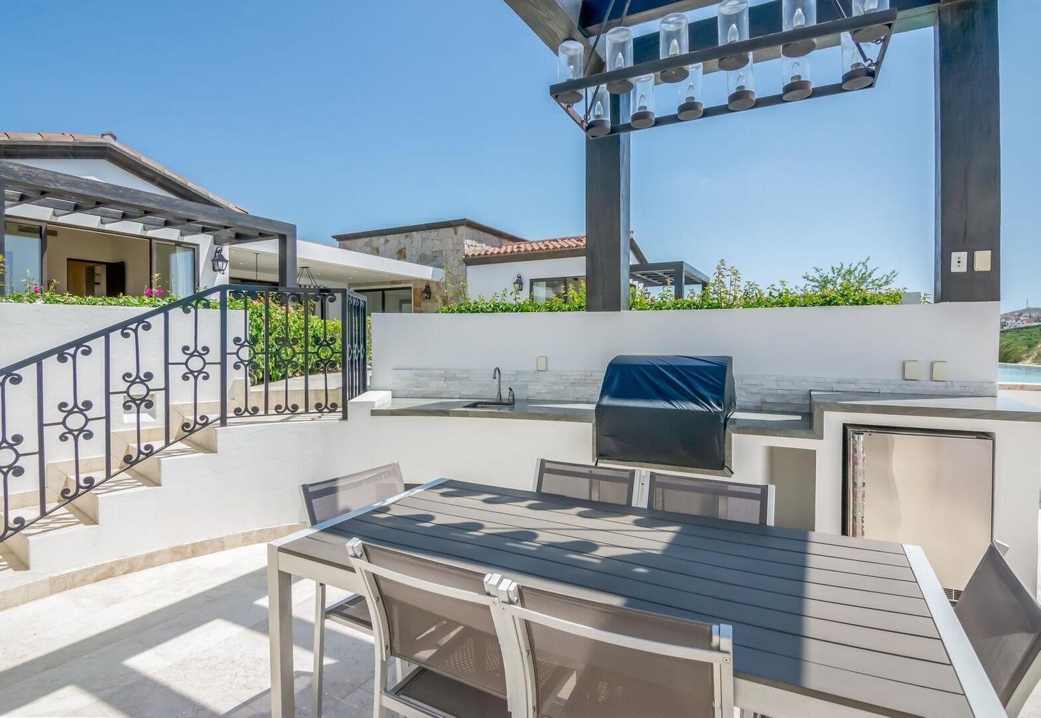 4.3 Coronado undefined, undefined 00000 - Photo 16 of 29 a view of a patio with table and chairs with wooden floor and fence