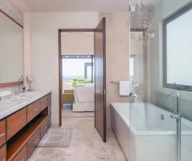 a bathroom with a tub sink and mirror