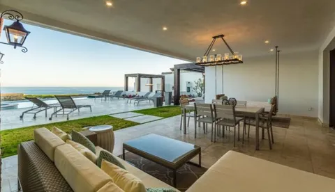 a dining room with furniture and a floor to ceiling window