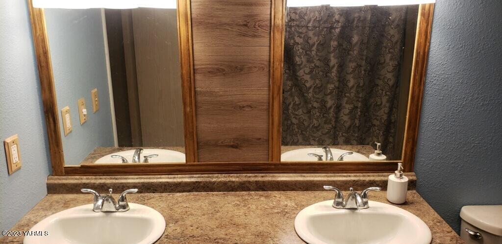 2833 Wiley Road Yakima, WA 98903 - Photo 13 of 17 a bathroom with a sink and a mirror