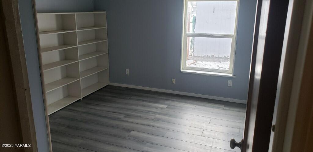 2833 Wiley Road Yakima, WA 98903 - Photo 16 of 17 a view of an empty room with wooden floor and a window