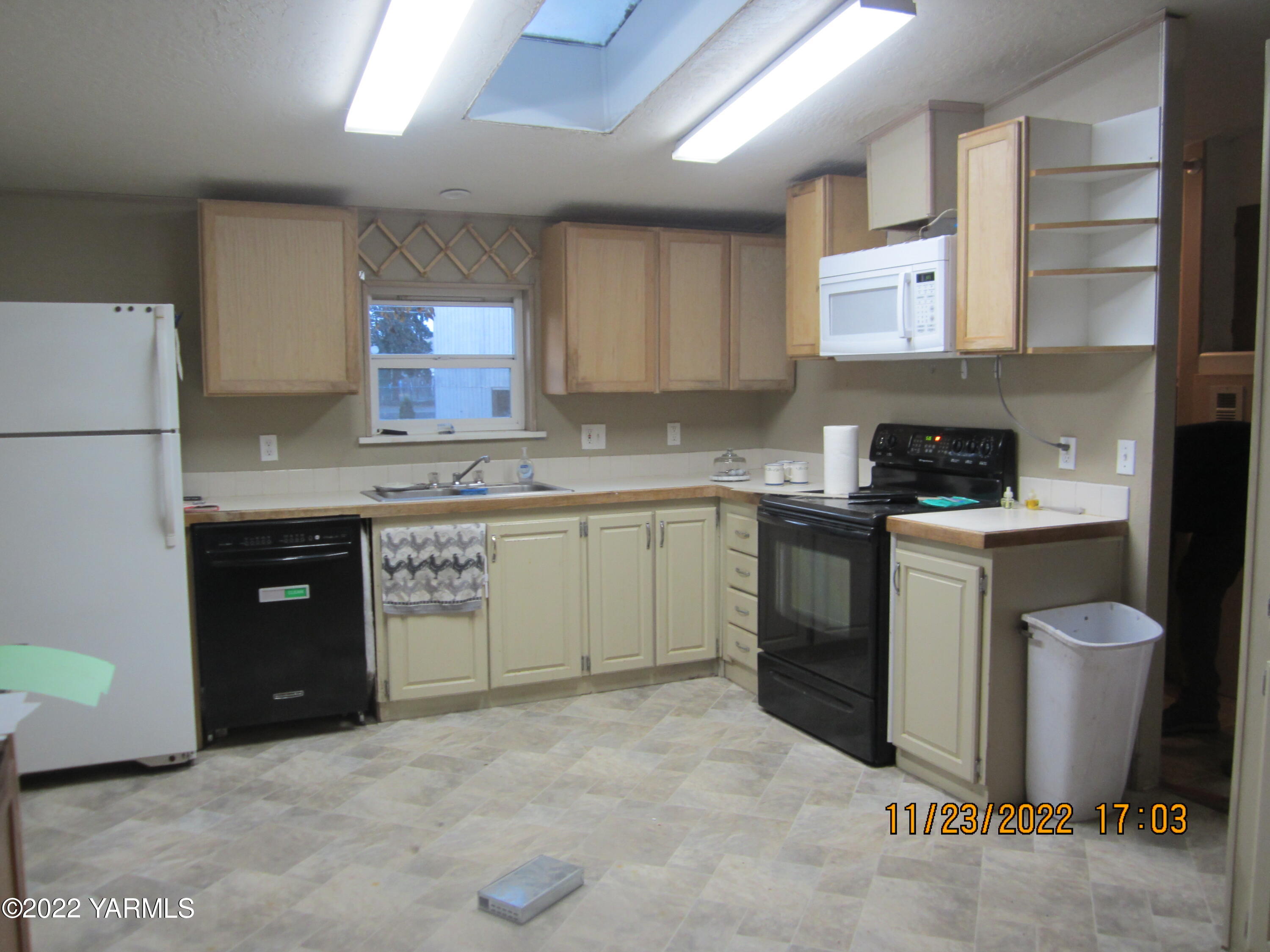 2833 Wiley Road Yakima, WA 98903 - Photo 2 of 17 a kitchen with a stove top oven sink and cabinets