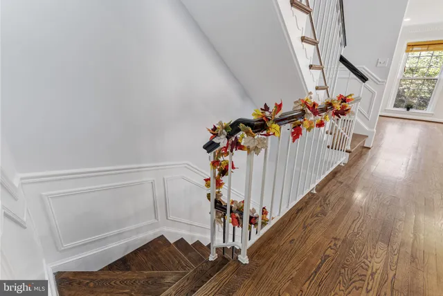 a view of an empty room with fire place and a window