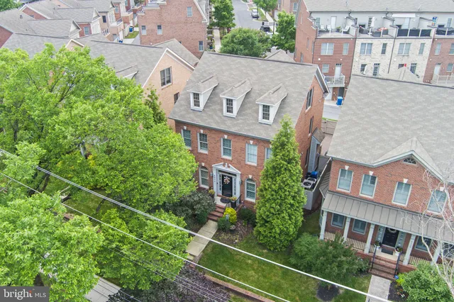 aerial view of a brick building next to a yard
