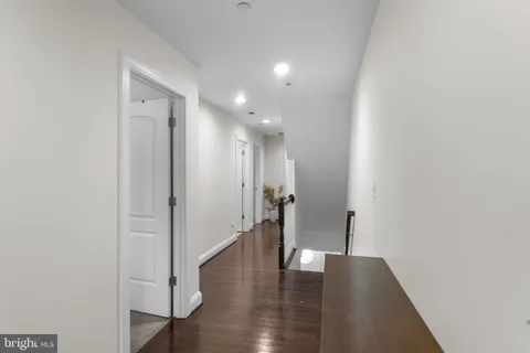 a view of hallway with wooden floor