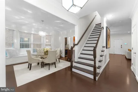 a view of a living room and entryway with furniture