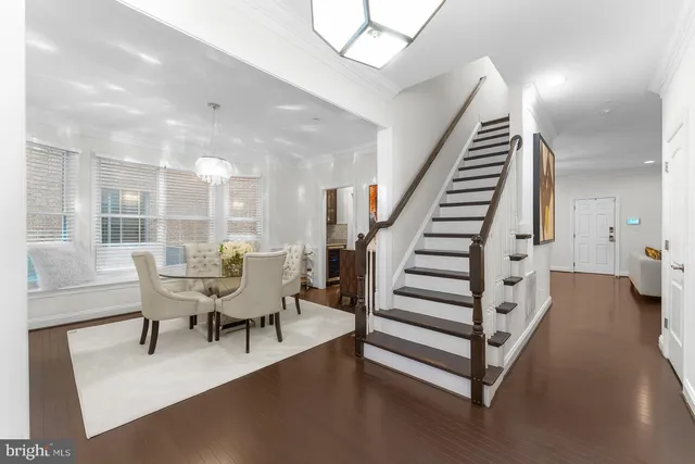 a view of a living room and entryway with furniture