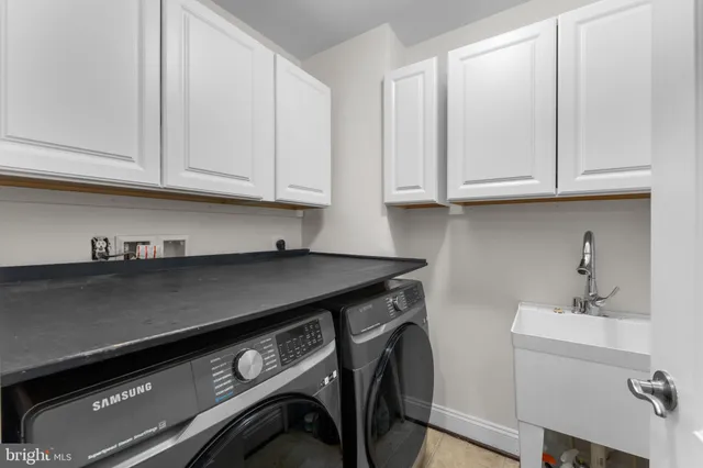 a kitchen with a sink cabinets and utility
